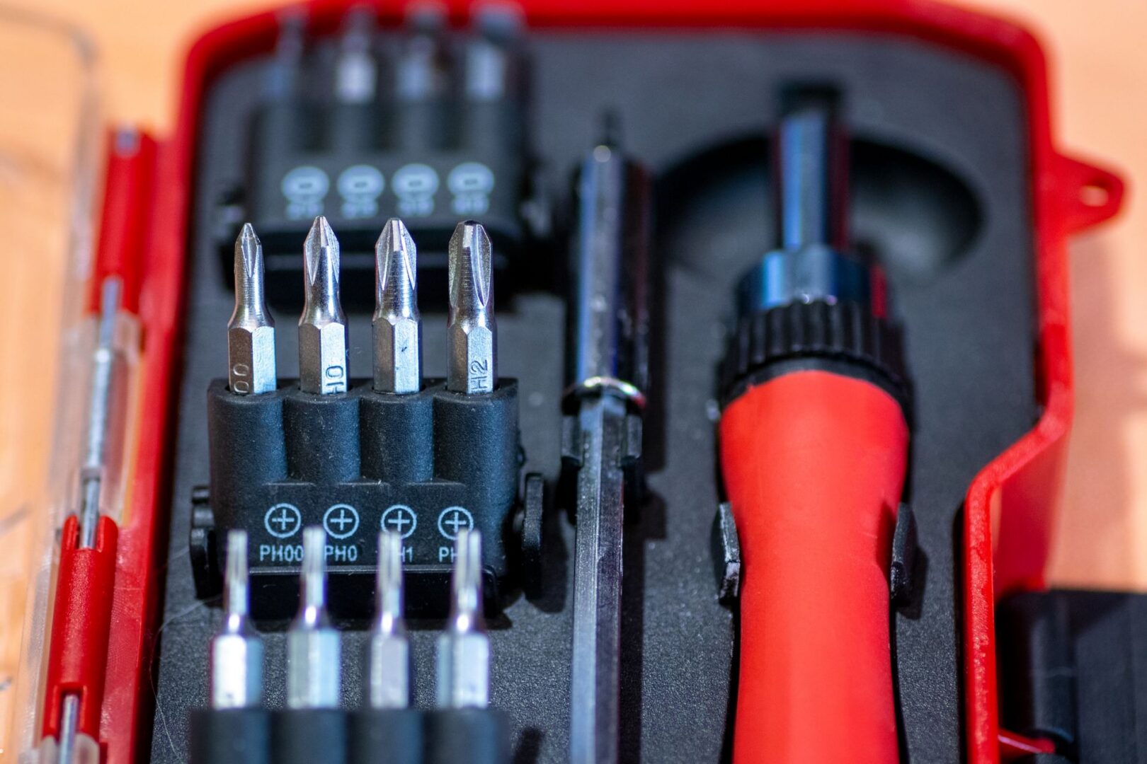 and open toolbox with red and black tools.