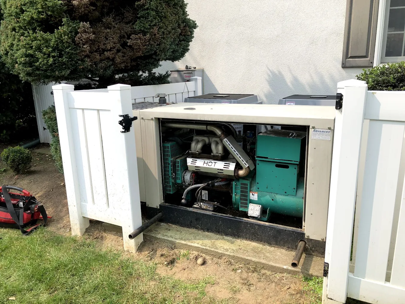 generator places behind a white fence.